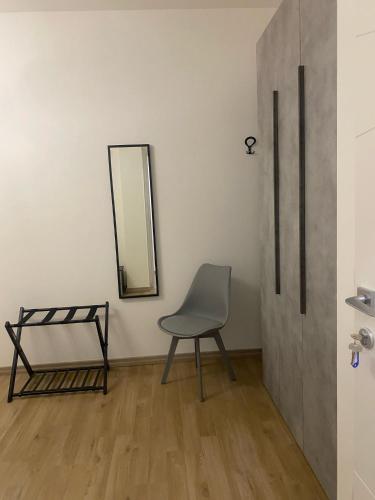 a chair in a room with a mirror at Le Ninfe Guest House in Cisterna di Latina