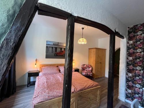 a bedroom with a bed with a wooden frame at Pension Winnemuller in Cochem