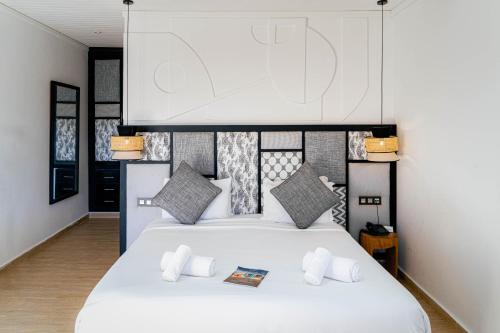 a bedroom with two beds with white sheets at Hotel Dakhla Club & SPA in Dakhla