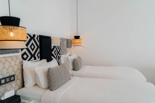 a living room with a white couch and pillows at Hotel Dakhla Club & SPA in Dakhla