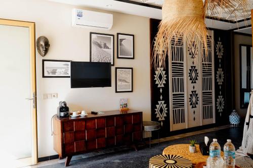 a living room with a tv on a wall at Hotel Dakhla Club & SPA in Dakhla
