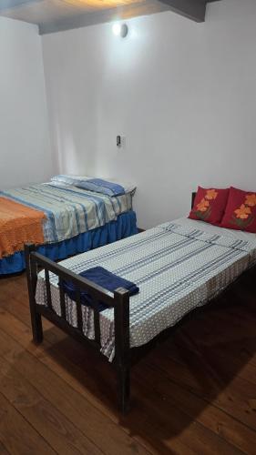 two beds sitting next to each other in a room at La Reina in Eldorado