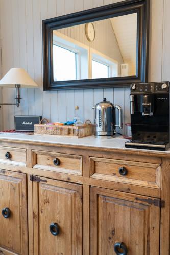 a mirror on top of a wooden dresser in a kitchen at Grund Cabin in Hvolsvöllur