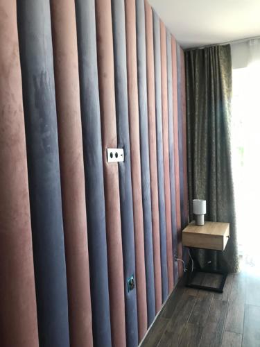 a room with a wall covered in curtains and a table at Villa Speranza Kościelna Droga 12 in Łomianki Dolne