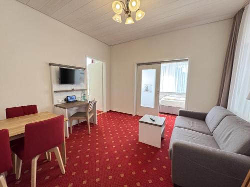 a living room with a couch and a table at Hotel Weisse Düne in Borkum