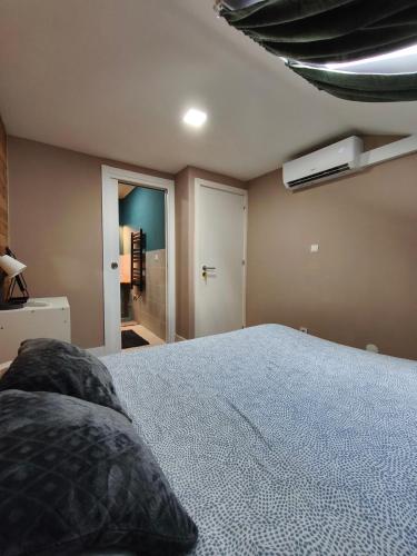 a bedroom with a large bed and a ceiling at Gaia Style Room in a Shared Apartment in Vila Nova de Gaia