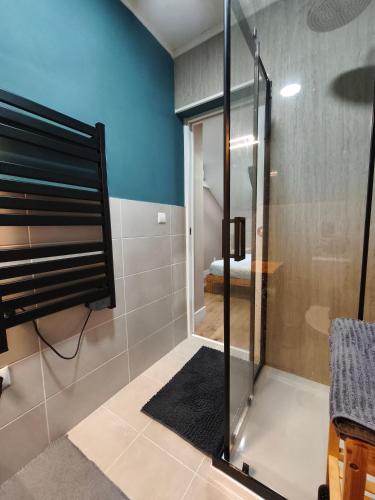 a shower with a glass door in a bathroom at Gaia Style Room in a Shared Apartment in Vila Nova de Gaia