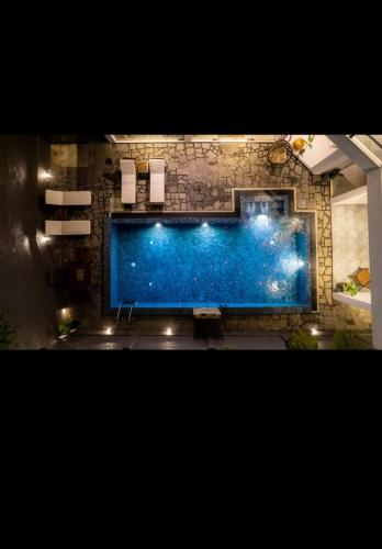 a large swimming pool in a room with lights at Villa Mossa Ambalangoda Boutique villa in Ambalangoda