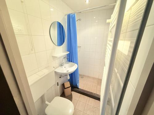 a bathroom with a sink and a toilet and a mirror at Bungalowpark Simpelveld - Schakel 15 in Simpelveld