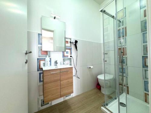 a bathroom with a toilet and a glass shower at Casa Ferrante in Cinisi