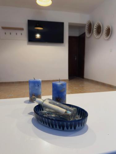 a blue bowl with a baseball bat and two candles at Villa Del Mare in Karpathos Town