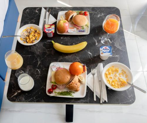 a table topped with plates of food and drinks at Dun Gorg Guest House in Marsaxlokk