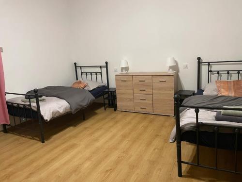 a bedroom with two bunk beds and a dresser at Pokoje w Gołdapi in Gołdap