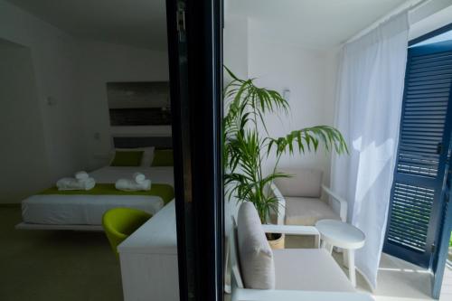a room with two beds and a plant in it at Hotel Boutique Es Blau in Cadaqués
