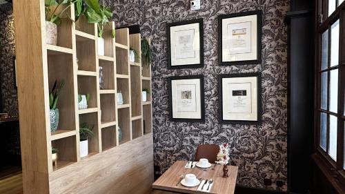 a dining room with a table and a wall at Hôtel Bristol in Le Touquet-Paris-Plage