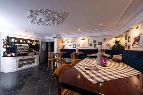 a restaurant with a table and chairs and a counter at Design Hotel ALPENLIEBE - - - - Boutique-Flair - - - - in Inzell