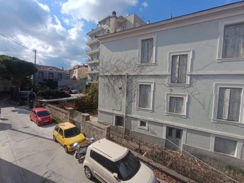 a yellow car parked in front of a building at Friendly Studio The bed is semi double in Mytilini