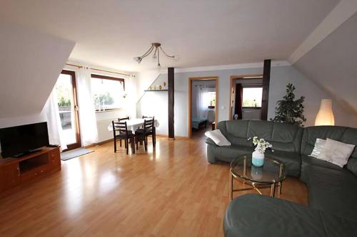 a living room with a couch and a table at Ferienwohnung Anna in Schwarz