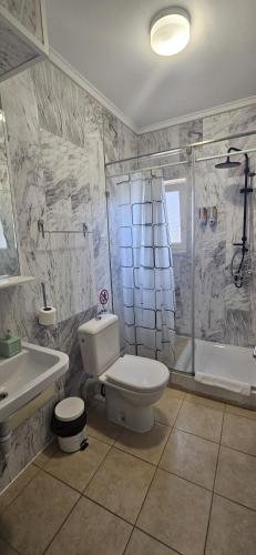 a bathroom with a toilet and a sink and a shower at Villa Merci Budva in Budva