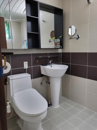 Noel's Darak Pension في دانيانغ: حمام مع مرحاض أبيض ومغسلة