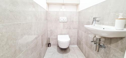 a bathroom with a sink and a toilet at Modern apartment in Košice in Košice