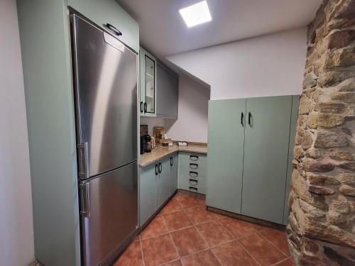 a kitchen with a large stainless steel refrigerator at Casa Laxeira in Tabagón