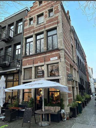an umbrella in front of a brick building at Pleasant apartment ready for you to enjoy in Antwerp