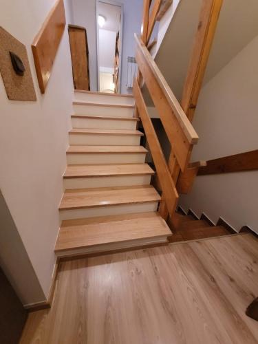 a staircase in a house with wooden floors at Agroturystyka Oblica in Zawoja