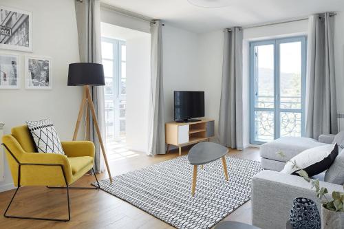 a living room with a couch and a tv at H SUITE3A by Smiling Rentals in Hondarribia