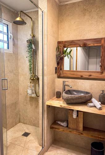 a bathroom with a sink and a shower at Ti'Laos in Cilaos
