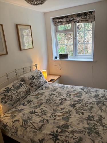 a bedroom with a bed and a window at Symonds Yat West Holiday Cottage 8 WRC with views of Yat Rock in Symonds Yat