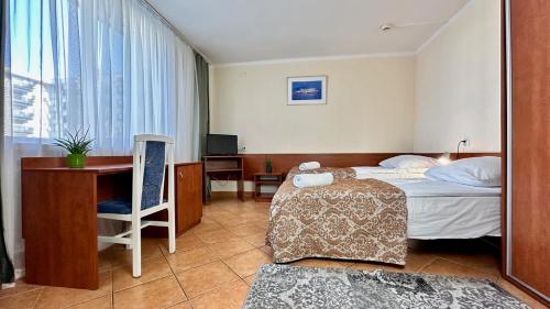 Postel nebo postele na pokoji v ubytování Hotel Turystyczny