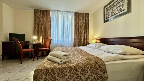 Postel nebo postele na pokoji v ubytování Hotel Turystyczny