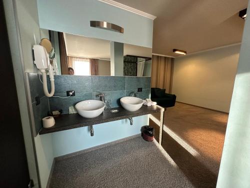 a bathroom with two sinks and a mirror at Regina Maria Spa Design Hotel in Balchik