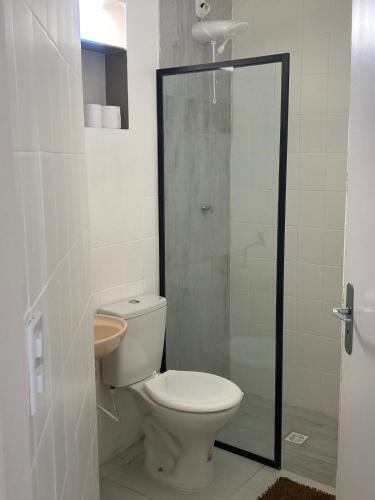 a bathroom with a toilet and a glass shower at Apartamento Studio 201 in Juazeiro