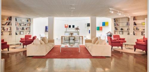 a living room with couches and chairs and a table at Sercotel Amister Art Hotel Barcelona in Barcelona