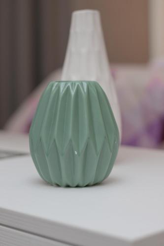 a green vase sitting on top of a table at NAFPAKTOS-luxury suite in Nafpaktos
