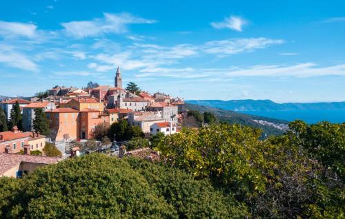a town on top of a hill with water at Luxury villa Hedone with pool in Rakalj in Rakalj