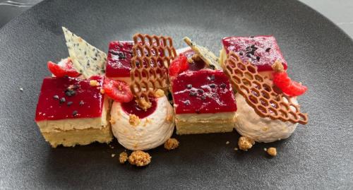 a plate of desserts with waffles and fruit on it at Le Clos Du Pontic Logis et Cit'Hotel in Landerneau