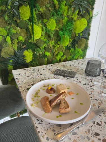 a plate of food sitting on a table at Le Clos Du Pontic Logis et Cit'Hotel in Landerneau