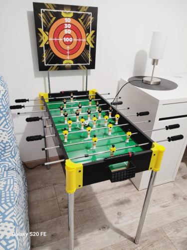 a ping pong table in a living room at Appartement à Sainte-Brieuc T3 CESSON in Saint-Brieuc