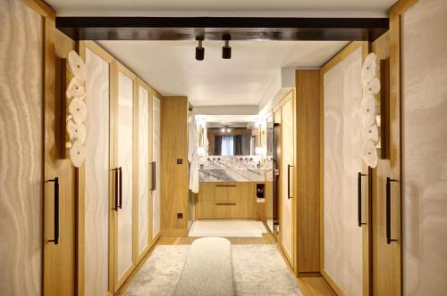 - un couloir avec des portes en bois et un tapis blanc dans l'établissement Elegance et Confort au Coeur de Paris, à Paris