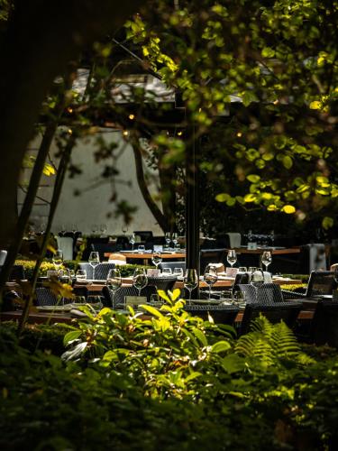 a group of tables and chairs in a park at Domaine les Crayères in Reims