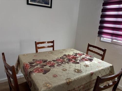 a table with a table cloth with roses on it at Alojamientos Capri in Quesada
