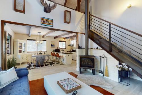 a living room with a blue couch and a fireplace at Sioux Serenity in South Lake Tahoe