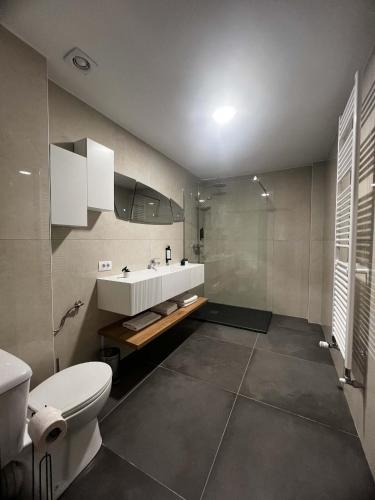 a bathroom with a white sink and a toilet at Mimi Hotel in Corabia