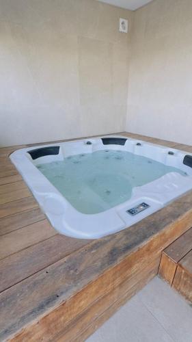 a large bath tub sitting on top of a wooden floor at Casa dos Barros - Vitorino dos Piães in Vitorino dos Piães