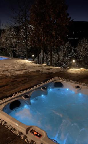 a hot tub in the snow at night at Brick Villas - Poolside Bliss in Novoberdo