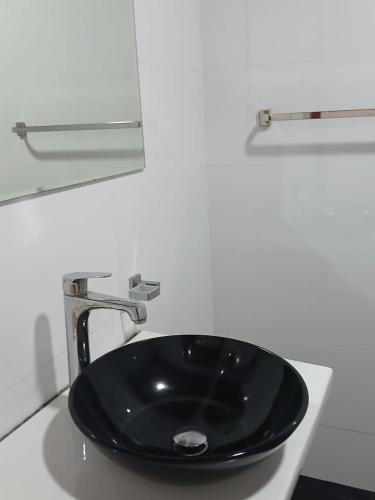 a black sink in a white bathroom at Green Peak - Mountain View Hotel & Restaurant in Ella