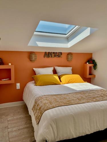 une chambre avec un grand lit avec une lucarne dans l'établissement Votre location tout confort, à Lançon-Provence